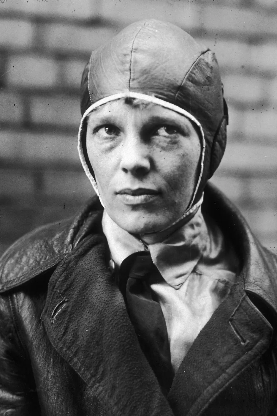 Photograph of Amelia Earhart wearing a leather flying helmet, 1928