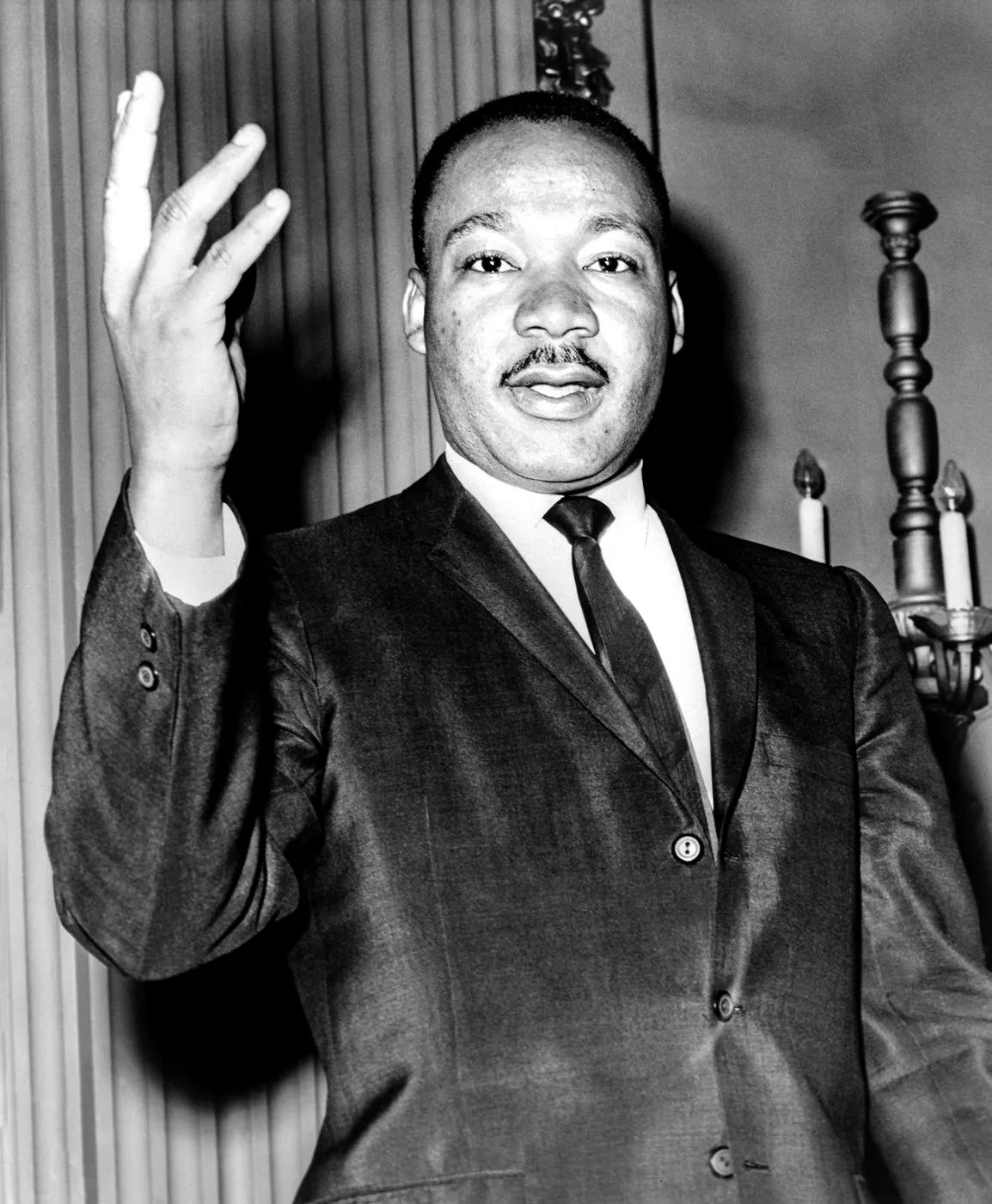 Martin Luther King Jr. raising his hand while speaking, 1964